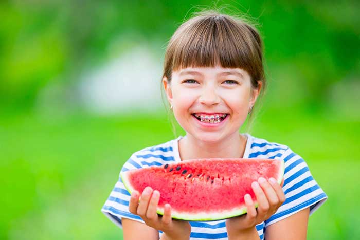 A girl holding watermelon